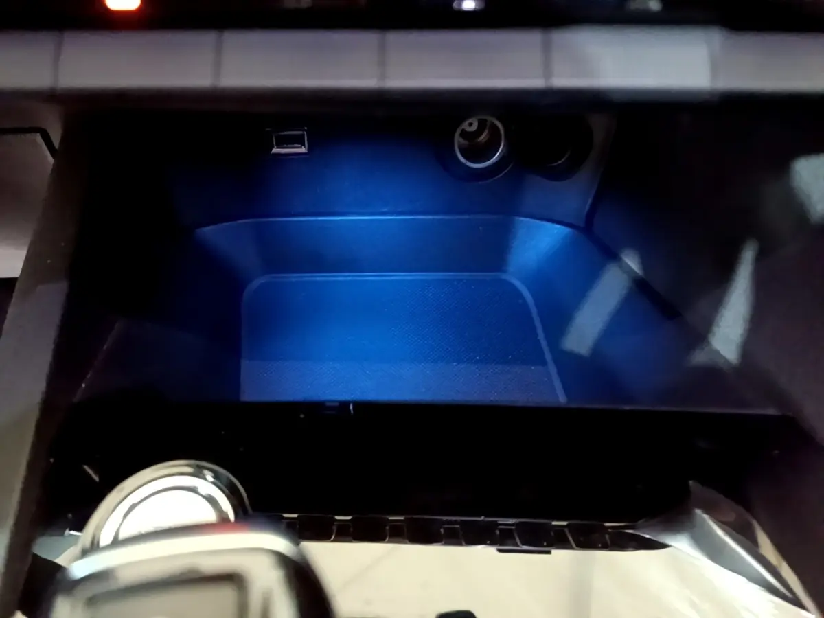 Espace de rangement intérieur éclairé en bleu avec prise USB et allume-cigare dans Peugeot 5008 bleu 2018.