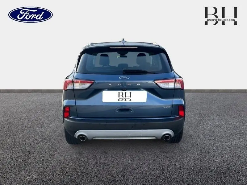 Vue arrière d'un Ford Kuga 2023 bleu azur métallisé avec double sortie d'échappement et feux arrière LED.