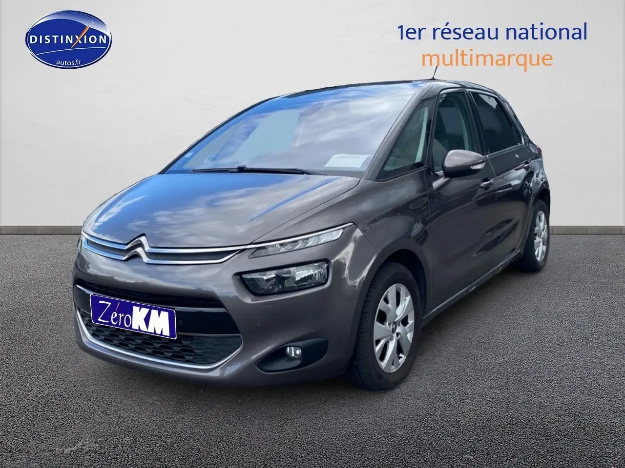 Citroën C4 Picasso gris vue 3/4 avant droit sur fond neutre avec phares et calandre distinctifs.