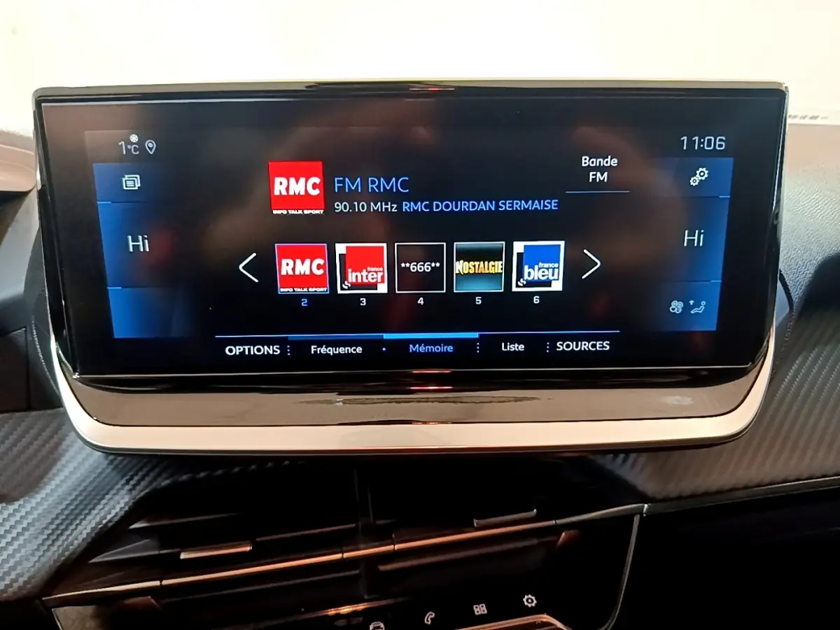 Écran tactile central 17,8 cm du tableau de bord d'une Peugeot 208, affichant les stations radio FM.