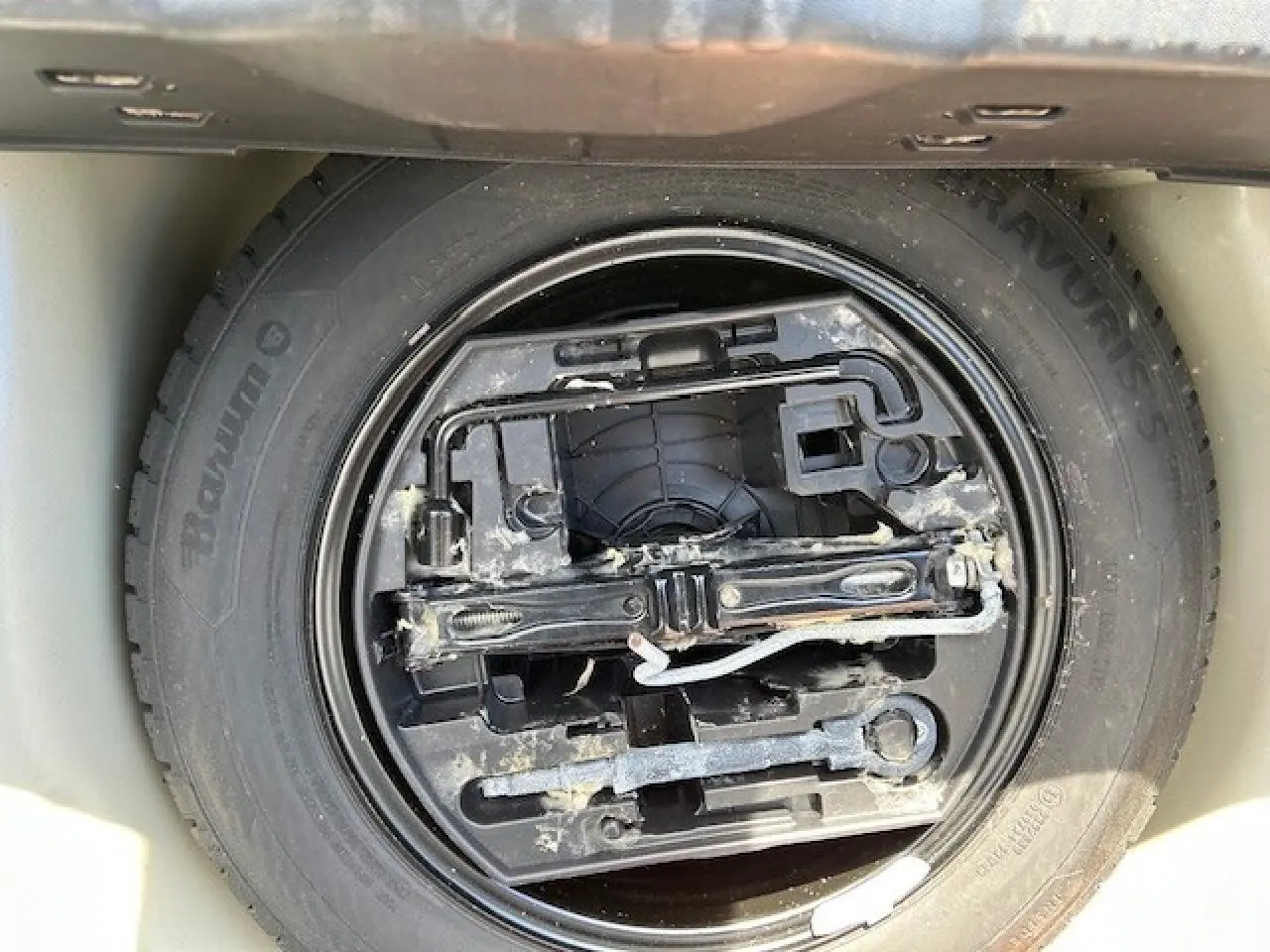 Gros plan sur la roue de secours et les outils de la CITROEN C3 1.2 PureTech 83 S&S C-Series 2021 sable métal.