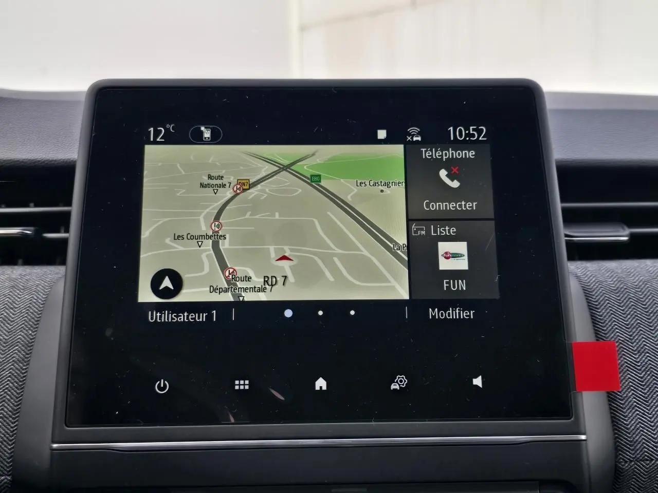 Écran tactile central de la Renault Clio V gris Rafale, affichant la navigation et les options téléphone à 10h52.