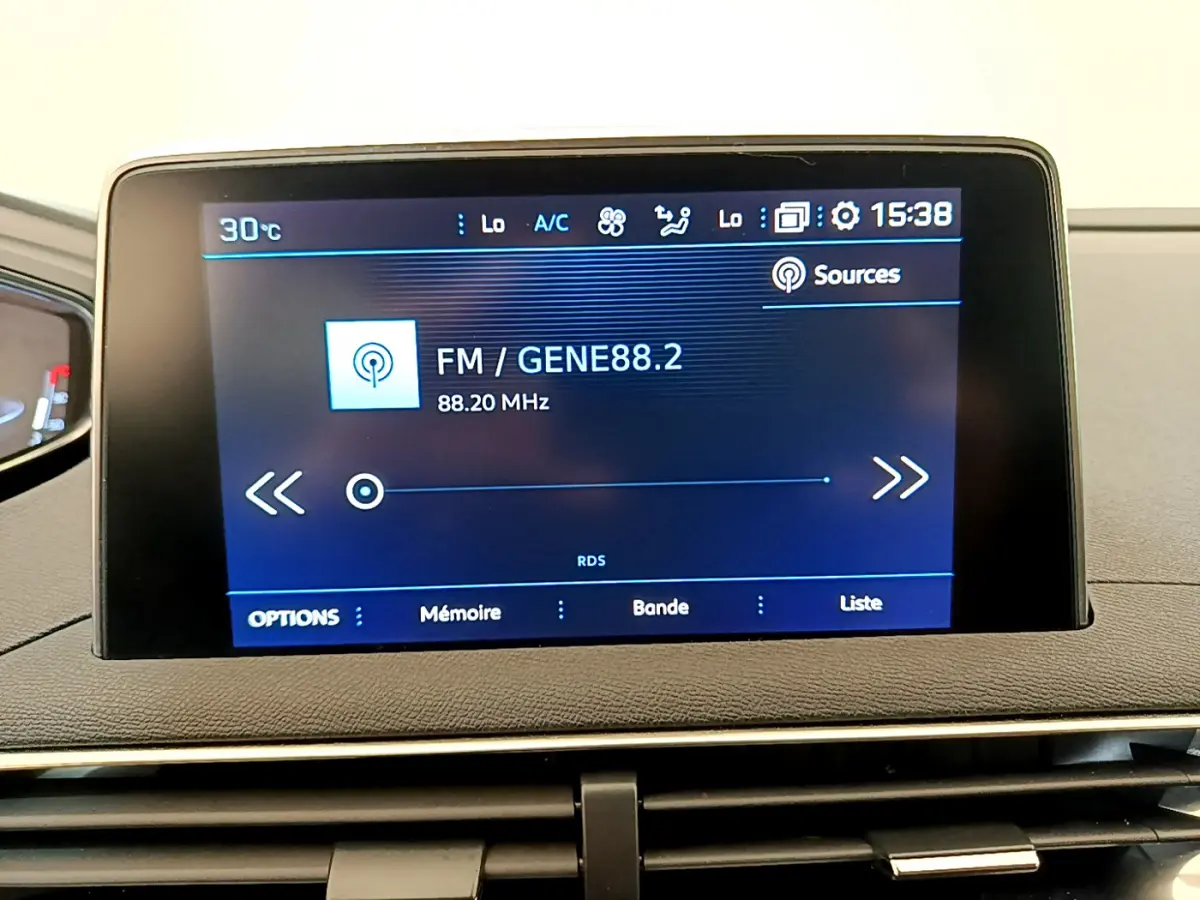 Écran tactile central affichant la radio FM dans l’habitacle du Peugeot 3008 gris foncé, version Puretech 130 S&S ACTIVE.