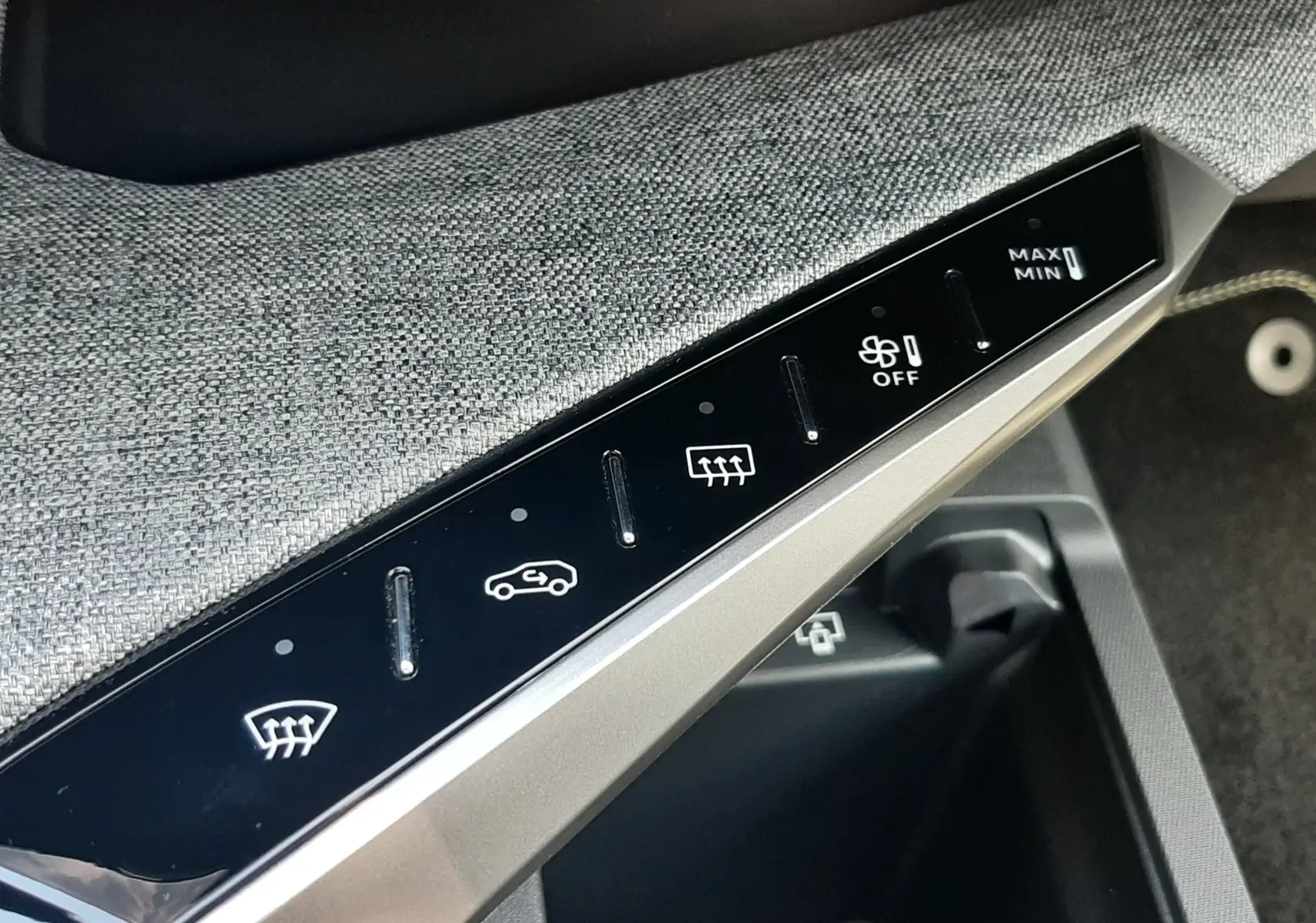 Détail de la console centrale du Peugeot 3008 1.2 Hybrid 145ch GT 2026, montrant les commandes tactiles du système de climatisation.