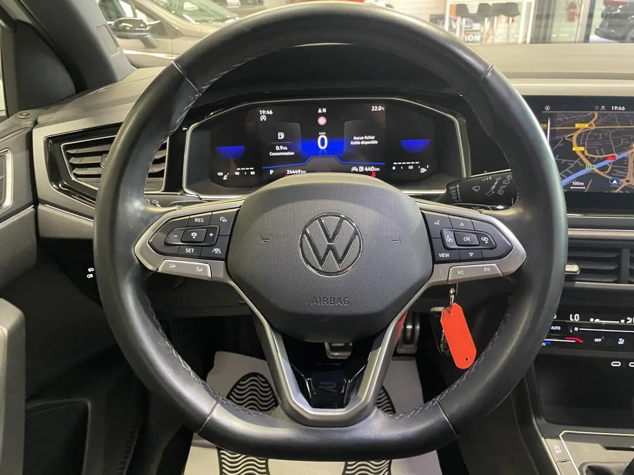 Vue intérieure centrée sur le volant cuir noir multifonction d'une Volkswagen Polo 2024 R-Line avec tableau de bord digital.