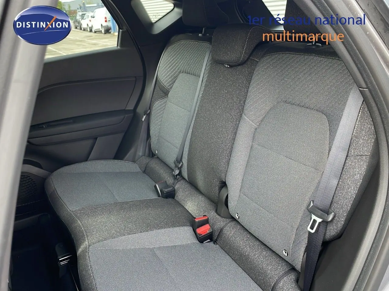 Vue intérieure montrant la banquette arrière en tissu gris du Renault Captur E-Tech F.Hybrid 2025, côté droit ouvert.