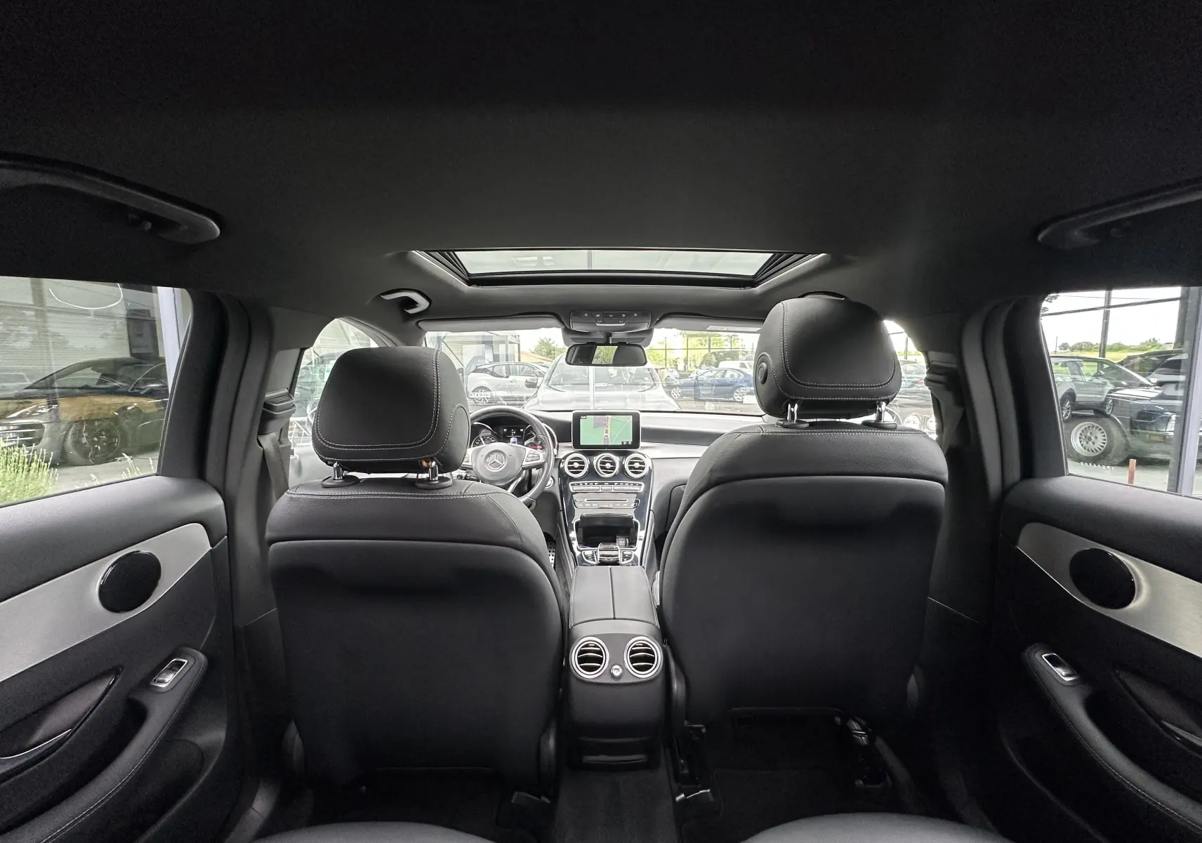 Vue intérieure arrière du Mercedes GLC Coupé 250 D Fascination 4MATIC 2018 avec sièges cuir noirs et toit ouvrant panoramique.