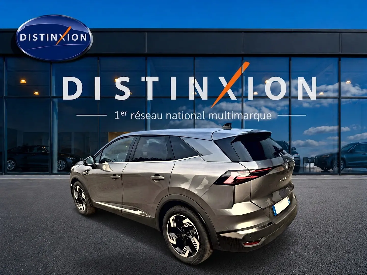Renault Symbioz gris cassiopée en 3/4 arrière droit, avec jantes alu et feux arrière LED distinctifs.