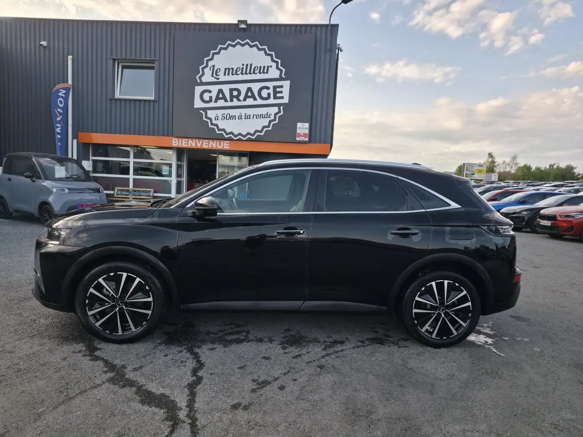 DS7 Crossback E-Tense 225 noir en profil droit, avec jantes alliage 19'' et barres de toit aluminium visibles.