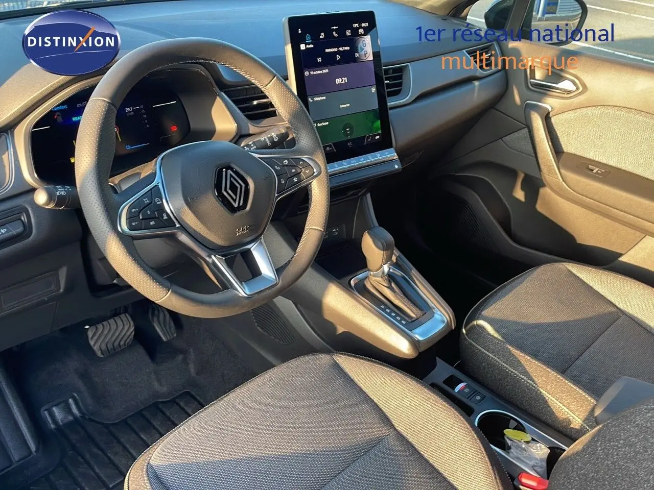 Intérieur du Renault Captur E-Tech Hybrid 2025 montrant le tableau de bord, volant multifonction et console centrale moderne.