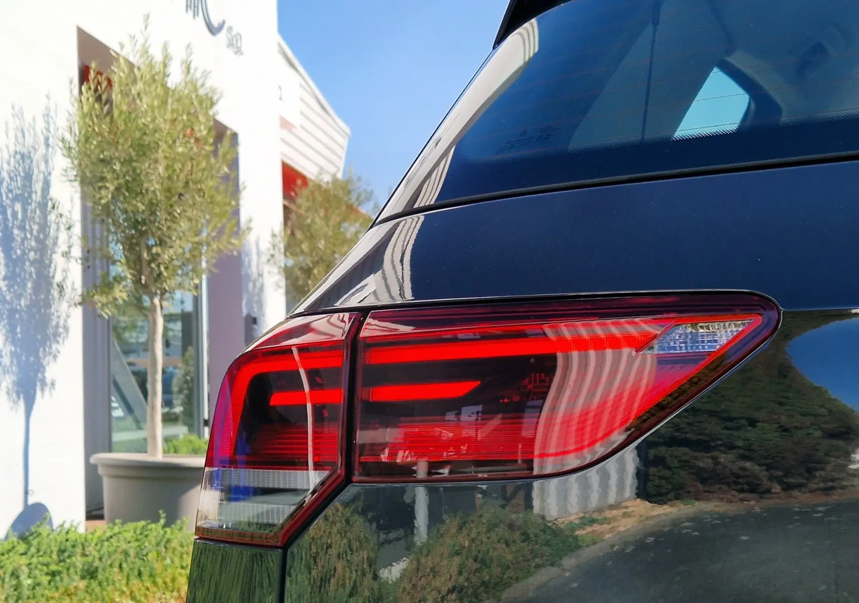 Gros plan sur le feu arrière droit rouge vif d'une Volkswagen Golf A8 2.0 TDI gris Urano 2023.