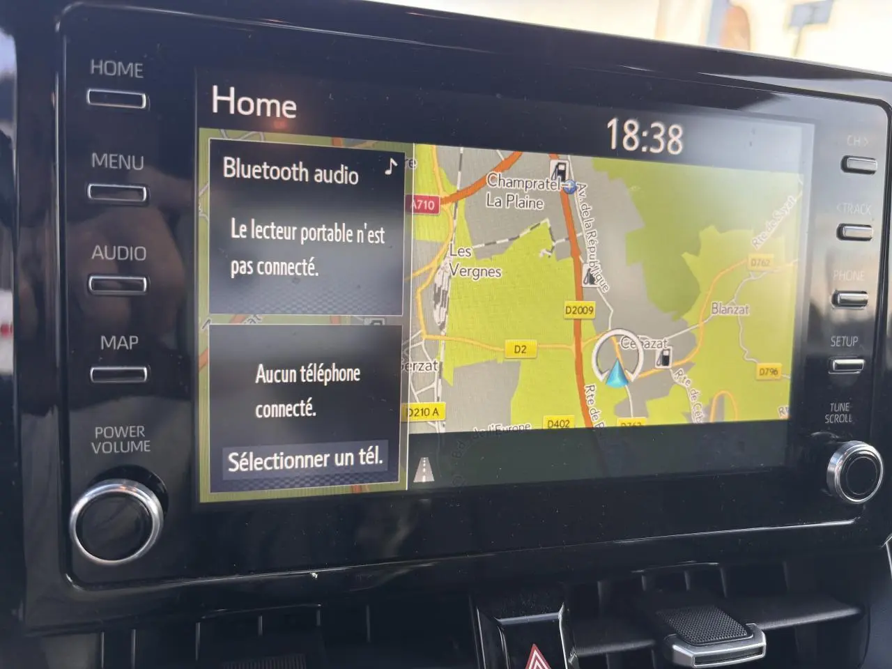 Écran central tactile de la Toyota Corolla hybride 2020 affichant la navigation et les options Bluetooth à 18h38.