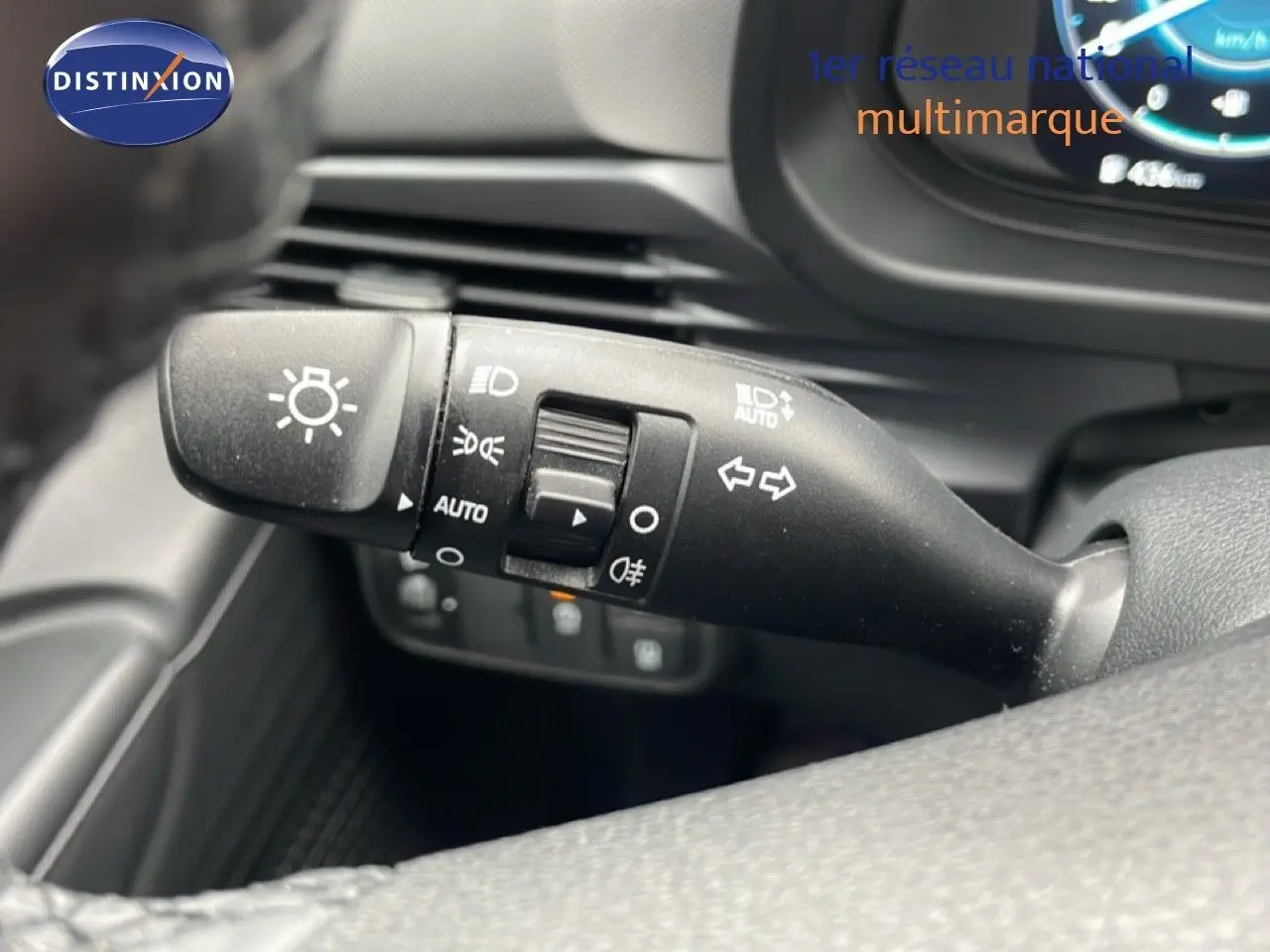 Gros plan sur la commande des feux et clignotants à gauche du volant dans l’habitacle d’une Hyundai i20 2025.