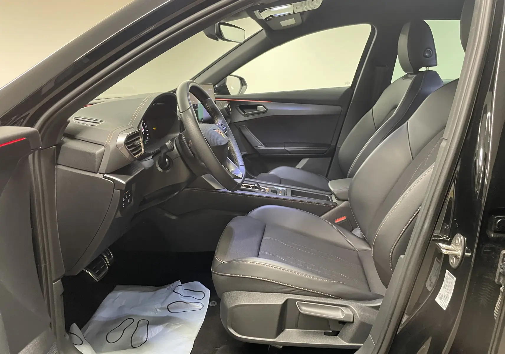 Intérieur avant droit du CUPRA Formentor noir Minuit avec sièges en cuir et tableau de bord moderne.