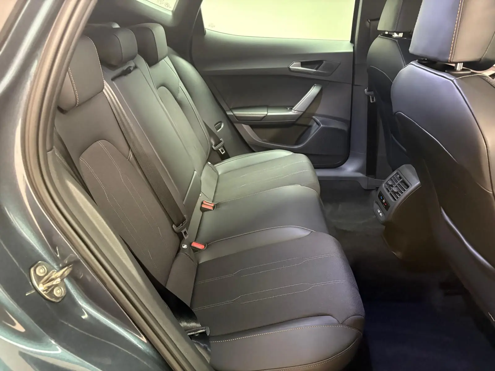 Banquette arrière en tissu gris avec surpiqûres, vue côté gauche de l'habitacle du CUPRA Formentor gris magnétique 2025.