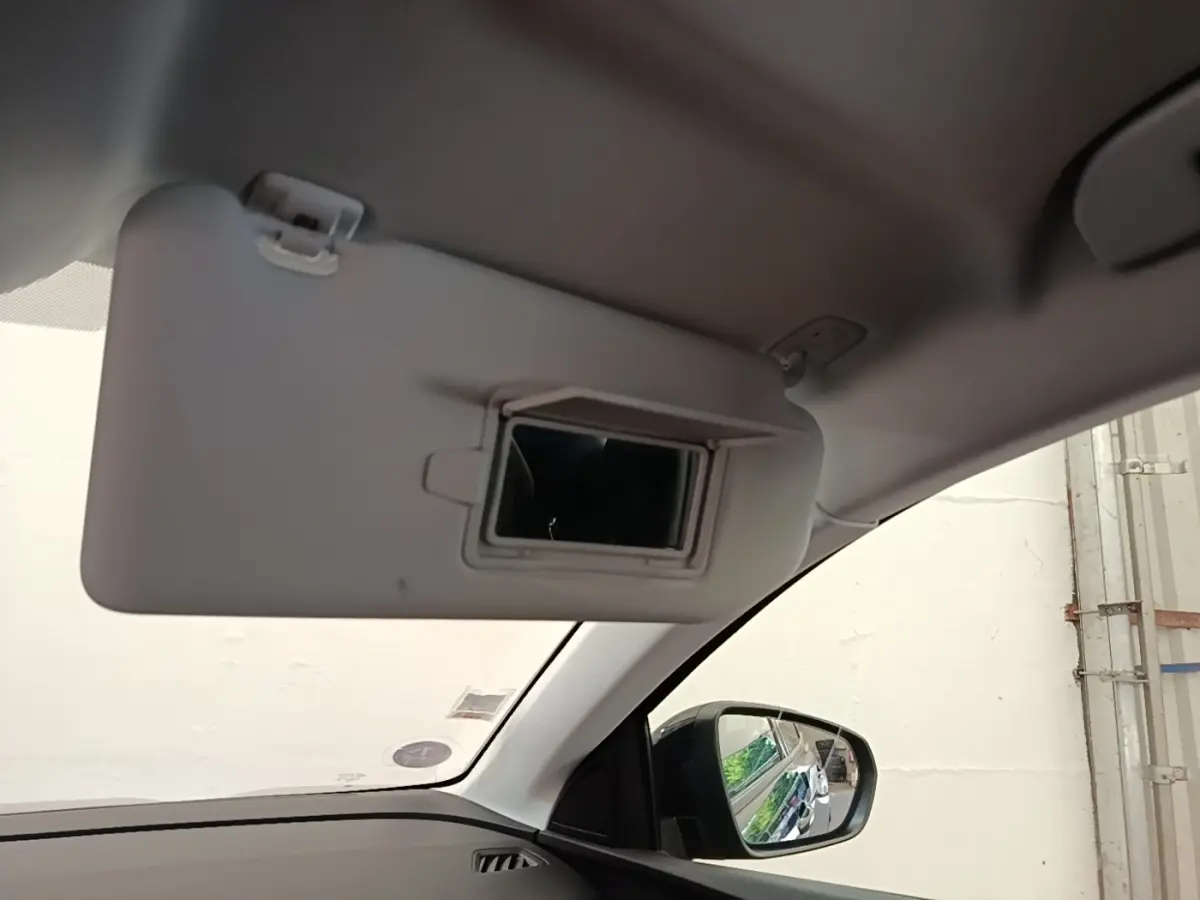 Vue intérieure côté conducteur du Peugeot 3008 noir 2022, avec pare-soleil abaissé et miroir de courtoisie visible.