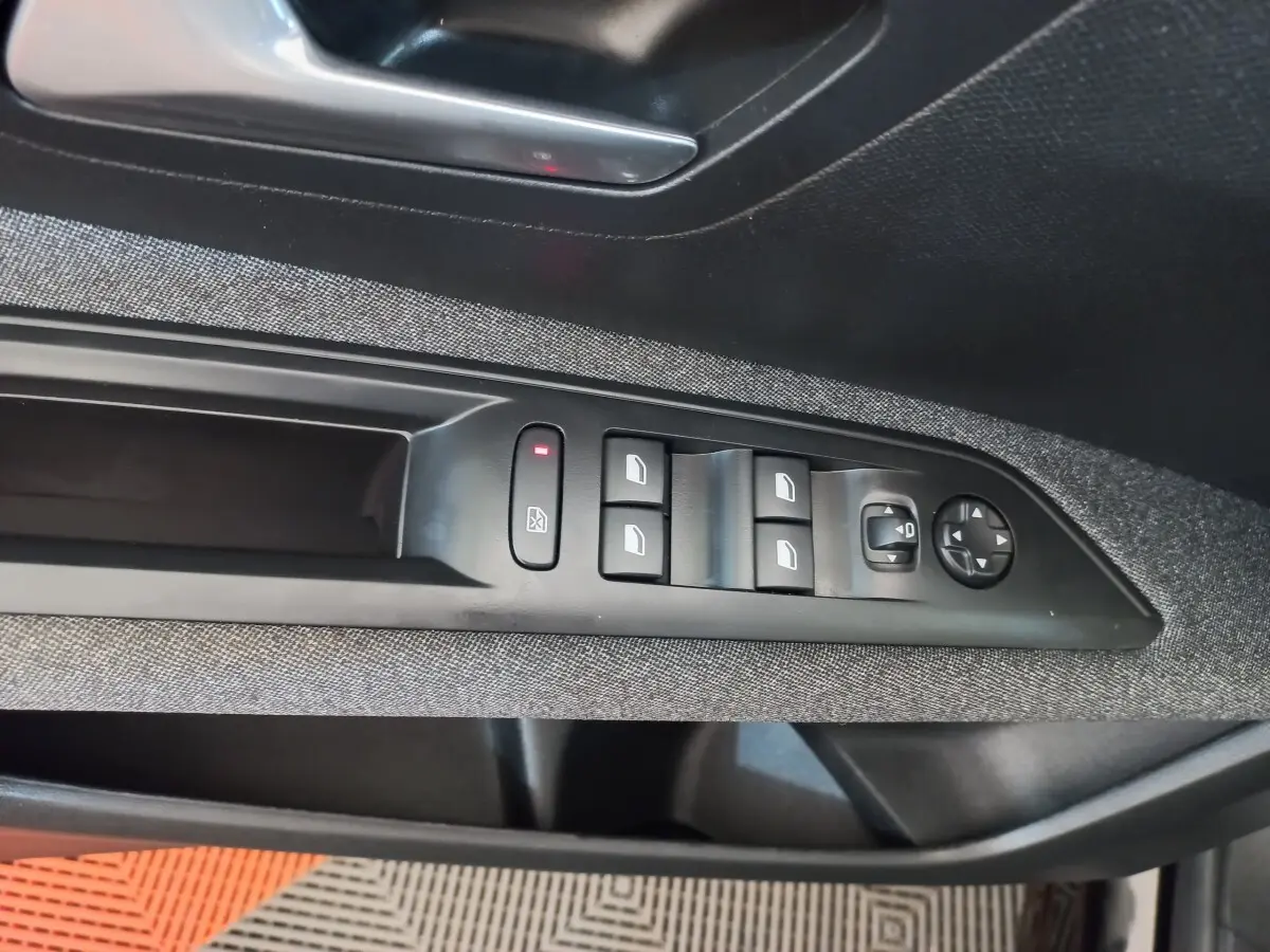 Commande des vitres électriques et réglage des rétroviseurs sur la porte côté gauche d’un Peugeot 3008 noir 2022.