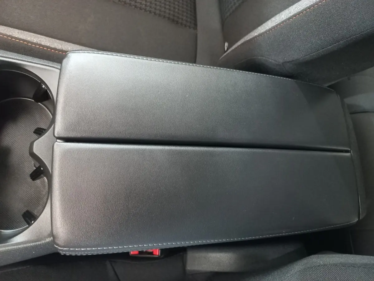 Accoudoir central noir en cuir vu de dessus dans l'habitacle du Peugeot 3008 PureTech 130 2022.