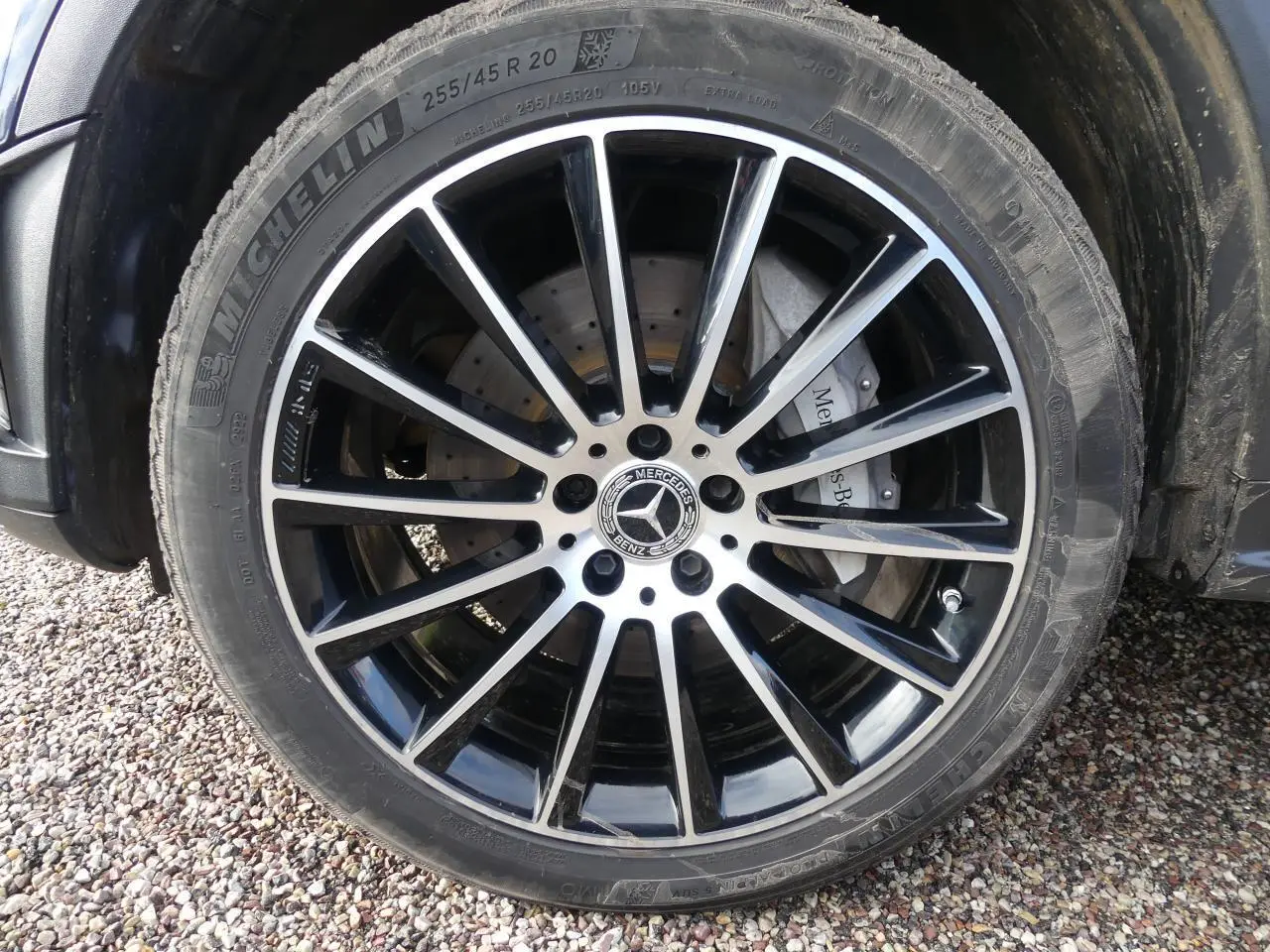 Gros plan sur la jante AMG noire et argentée de 20 pouces du Mercedes GLC Coupé bleu foncé.