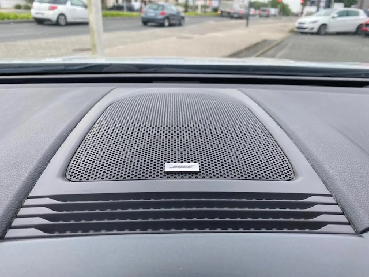 Gros plan sur l'enceinte Bose intégrée au tableau de bord du Renault Koleos blanc 2019, version Initiale Paris.