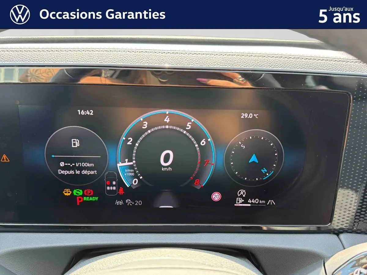 Tableau de bord numérique du Volkswagen Tiguan 2025 affichant vitesse, température et autonomie, vue frontale intérieure.