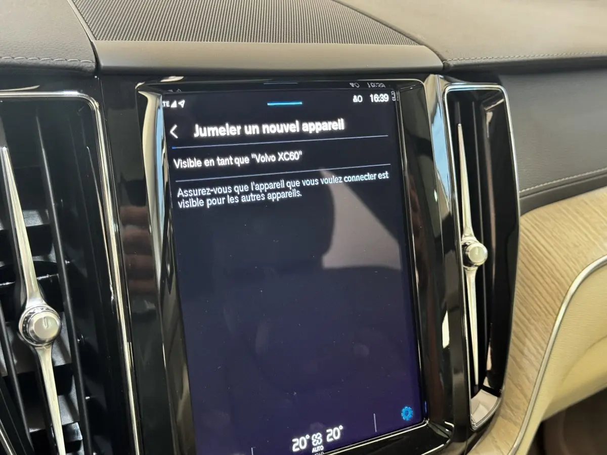 Écran tactile central affichant jumelage Bluetooth dans l’habitacle beige et noir du Volvo XC60 bleu.