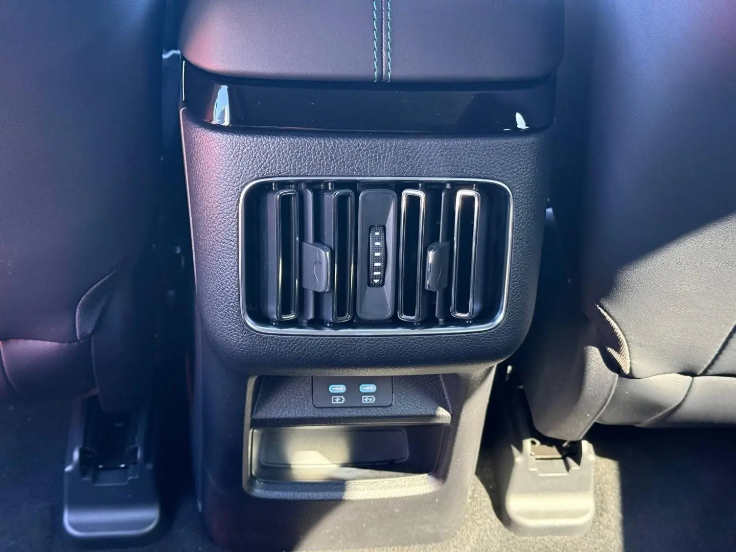 Vue rapprochée des aérateurs arrière et ports USB du tunnel central noir dans l’habitacle du BYD SEAL U 2026.