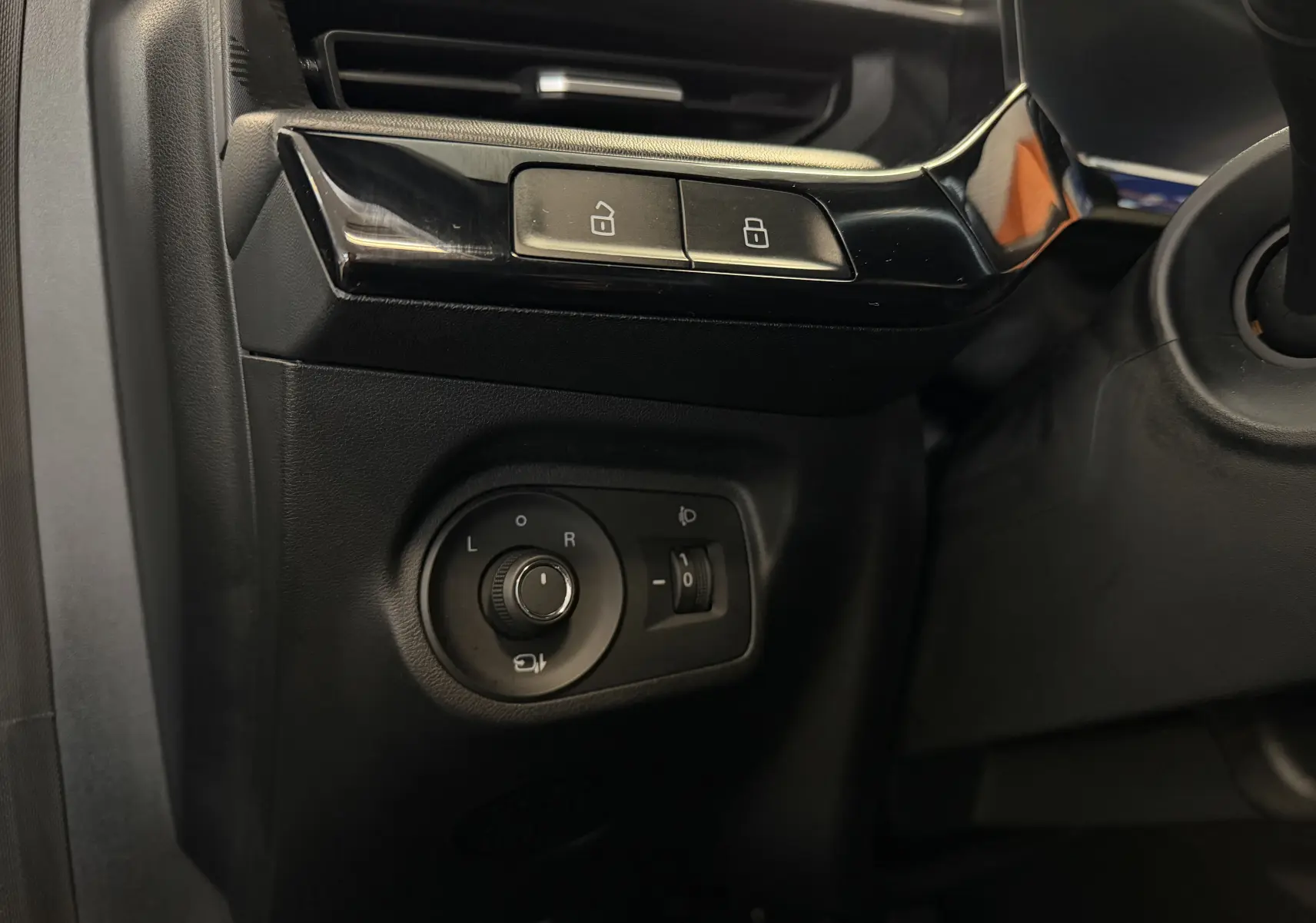 Gros plan sur les commandes de réglage des rétroviseurs et des serrures côté gauche intérieur noir du MG3 cosmic silver 2025.
