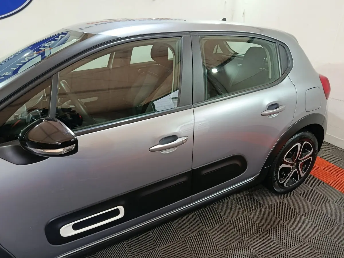 Vue latérale droite d'une Citroën C3 gris clair 2024 avec protections de porte noires et jantes stylisées.