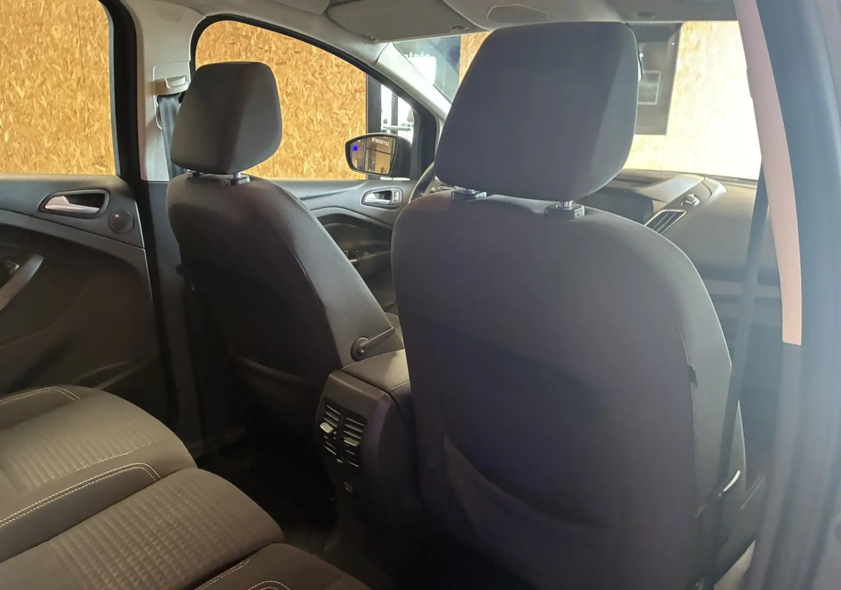 Intérieur arrière du Ford C-MAX gris 2015, vue côté droit montrant sièges tissu gris-noir et console centrale.