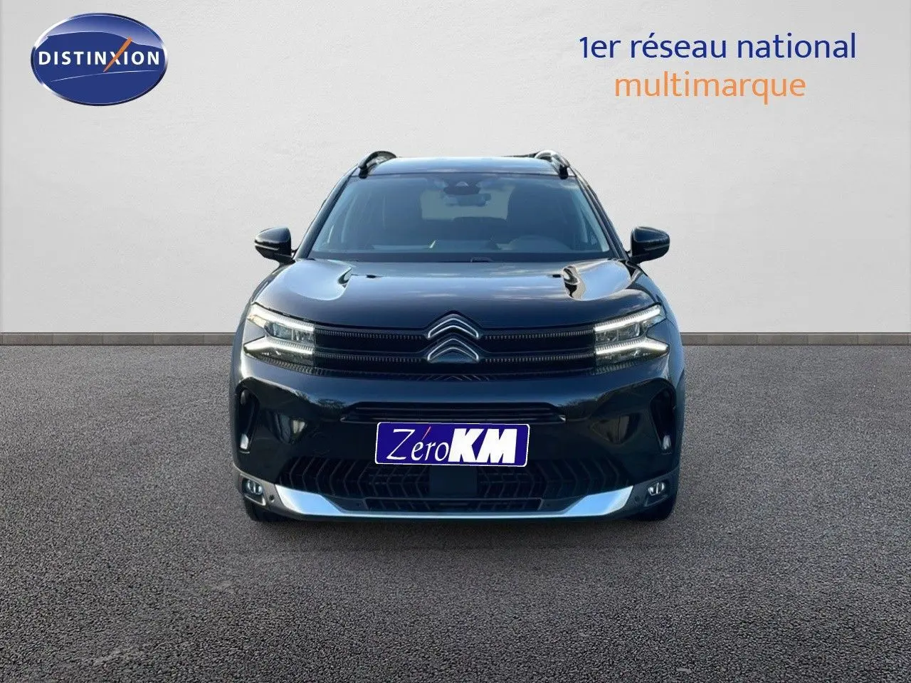 Vue frontale d'un Citroën C5 Aircross noir perla metal avec calandre distinctive et phares LED allumés.