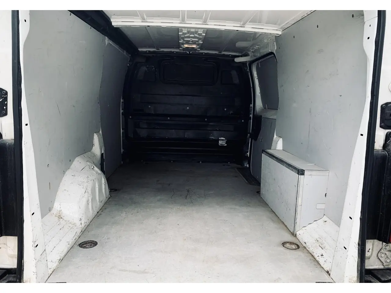 Vue intérieure de l'espace de chargement blanc du Citroën Jumpy XL 2020 avec cloison tôlée et anneaux d'arrimage.