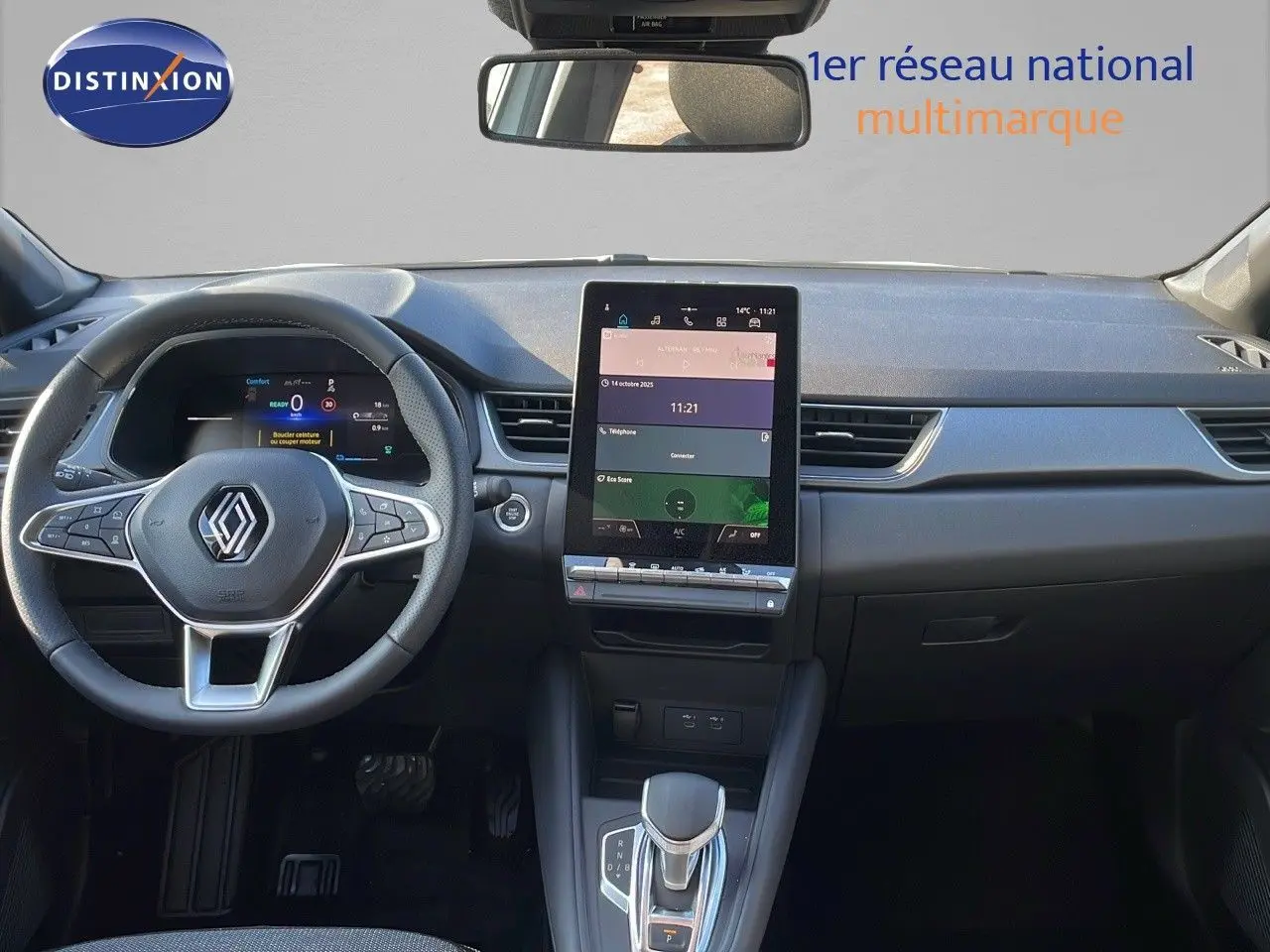 Vue intérieure frontale du tableau de bord du Renault Captur E-Tech hybride, avec écran tactile vertical et volant multifonction noir.