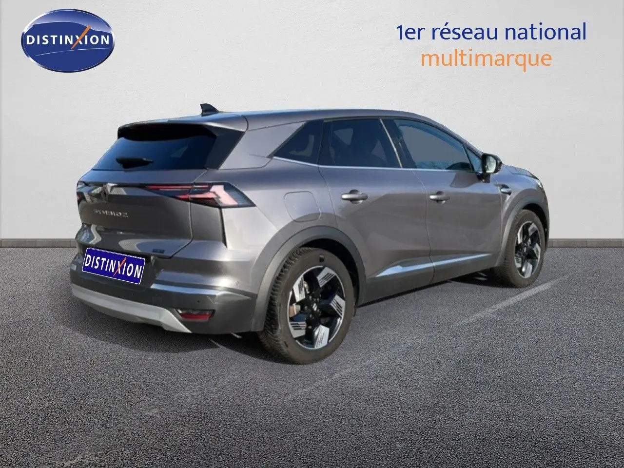 Renault Symbioz gris cassiopée métal en 3/4 arrière droit, soulignant ses lignes modernes et ses jantes stylisées.