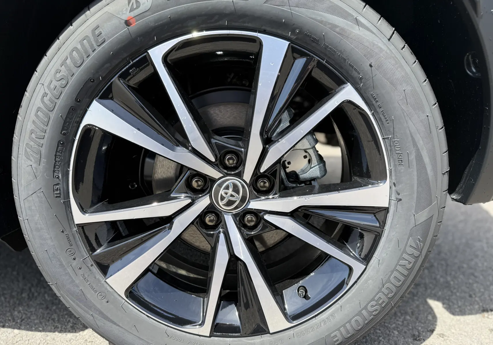 Gros plan sur la jante alliage noire et argentée du Toyota C-HR 1.8 Hybride 140 Style gris Atlas de 2025.