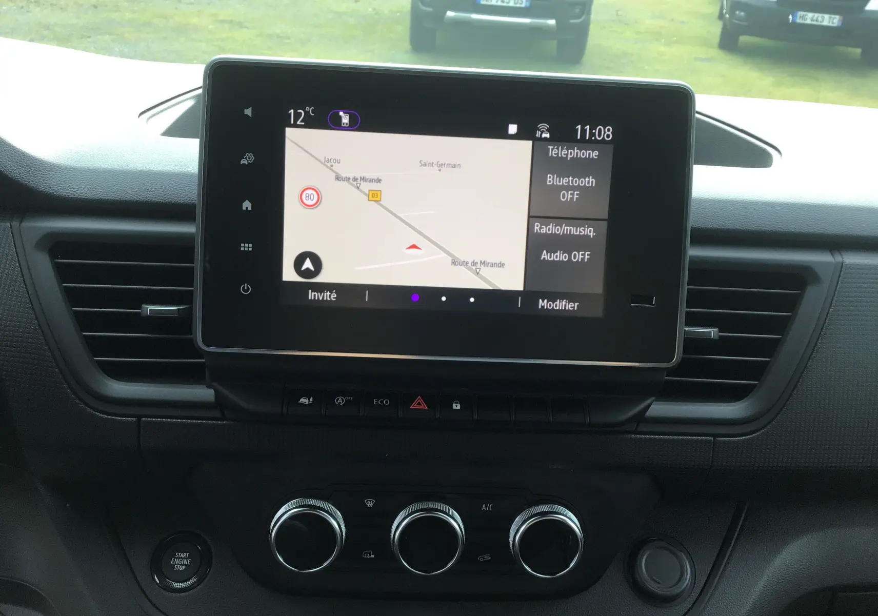 Vue rapprochée de l’écran tactile central du Renault Trafic Fourgon 2025 avec navigation et commandes climatisation visibles.