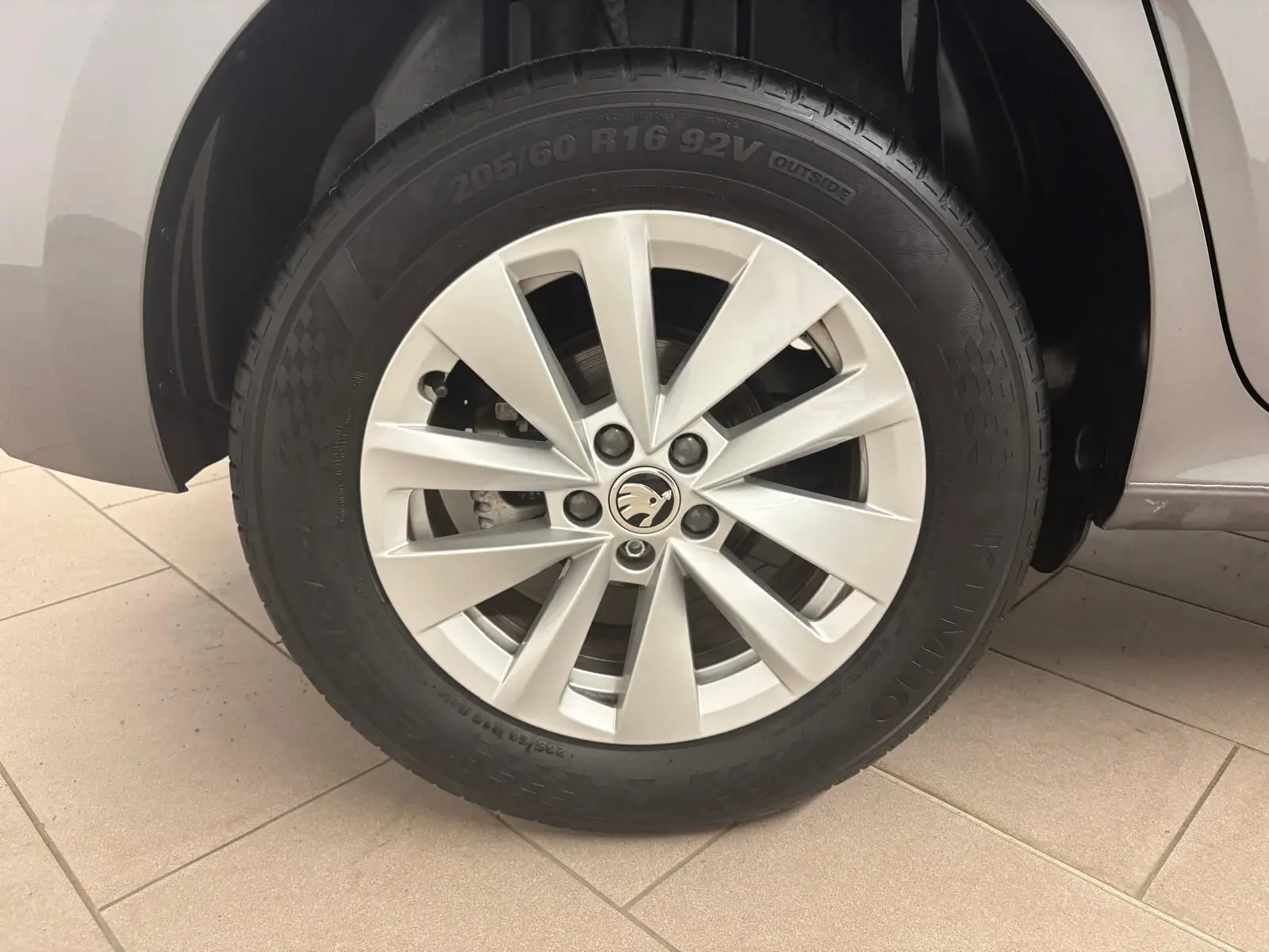 Gros plan sur la roue avant gauche du Skoda Kamiq 2023 gris graphite avec jante alliage et pneu Kumho.