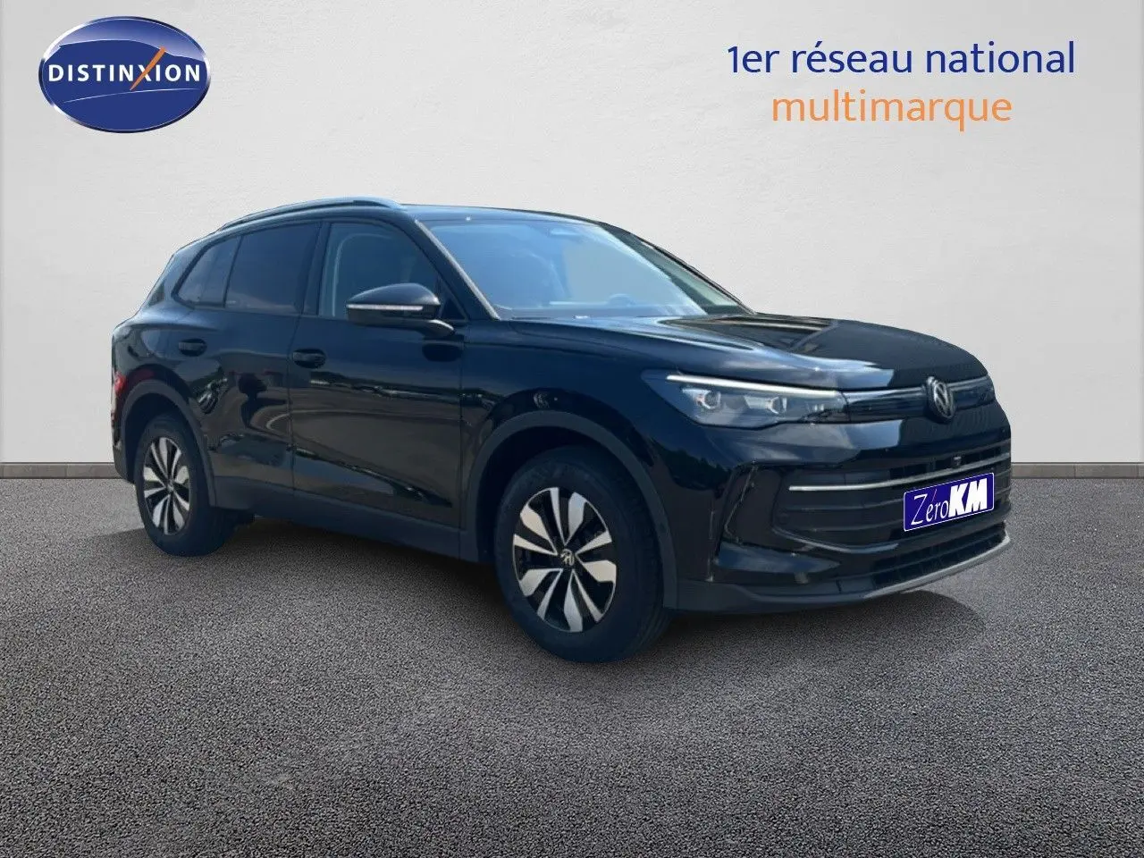 Volkswagen Tiguan noir grenadilla métal en 3/4 avant droit, avec jantes bi-ton et calandre moderne.