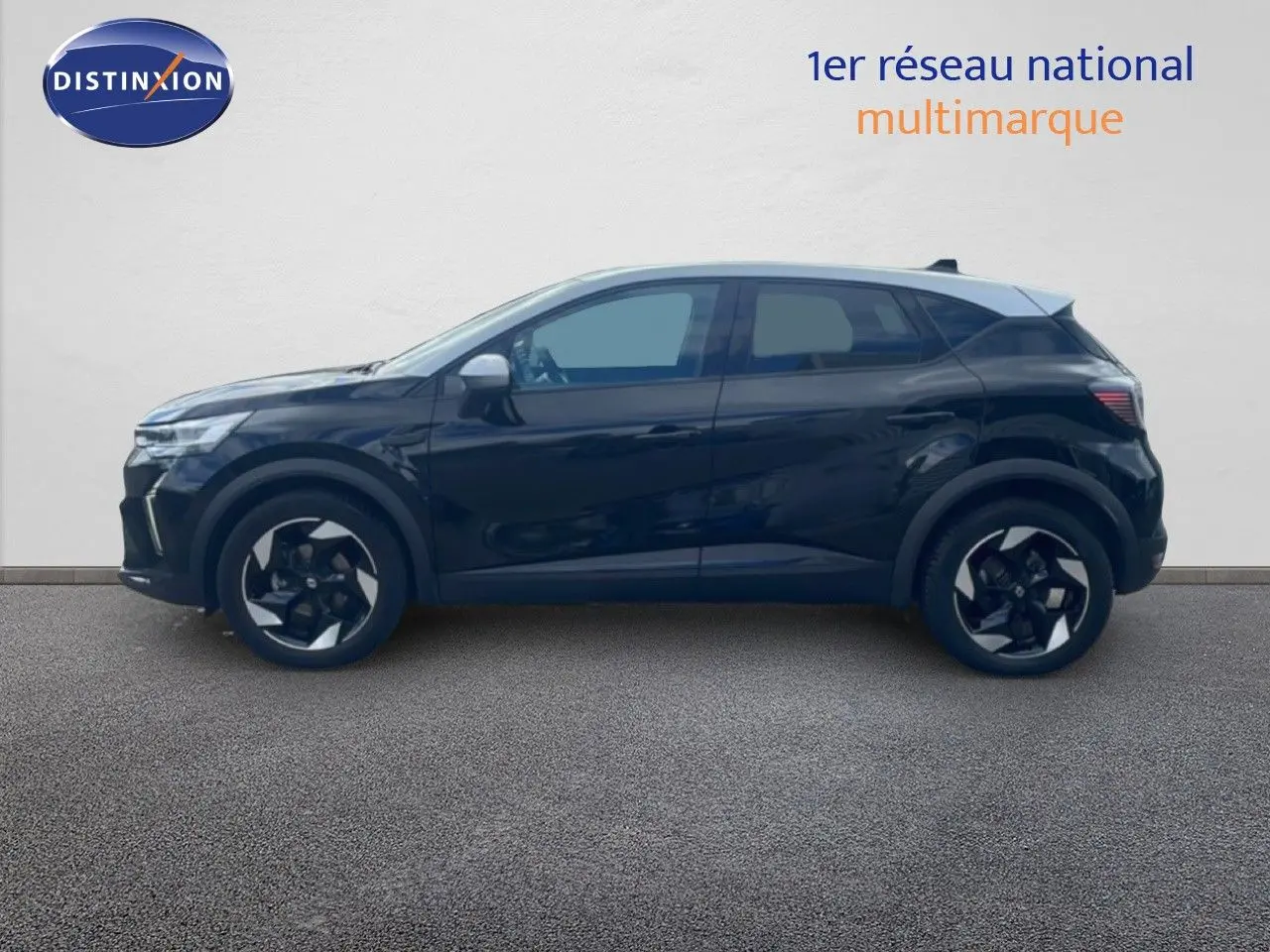 Profil droit d'un Renault Captur 2025 noir étoile métal avec toit gris, jantes bi-ton et lignes modernes.