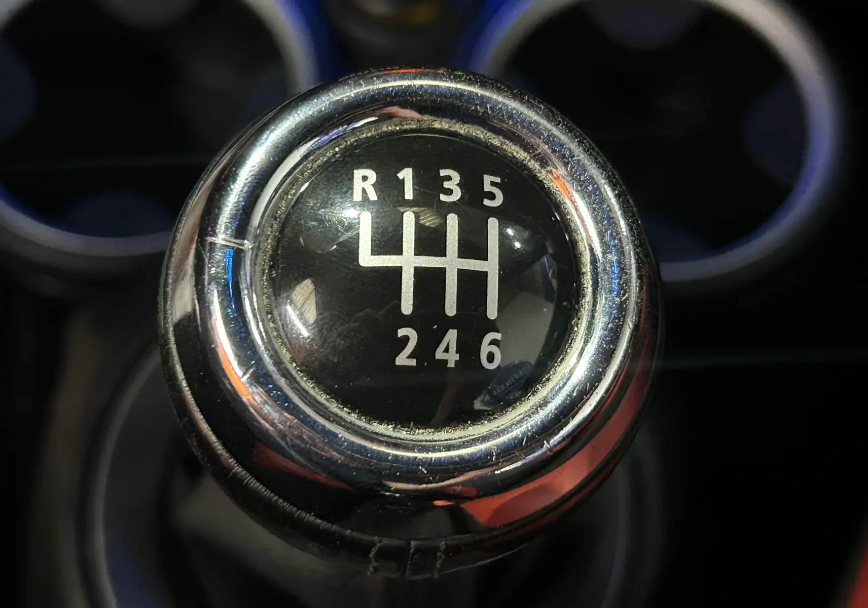 Gros plan sur le pommeau de la boîte manuelle 6 vitesses d'une MINI Cabriolet Cooper S rouge de 2012.