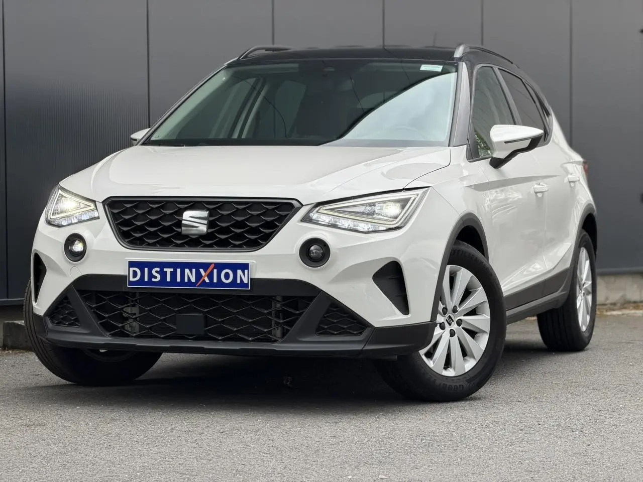SEAT Arona TSI 115 DSG Style blanc en 3/4 avant droit avec calandre noire et jantes alliage 16 pouces.