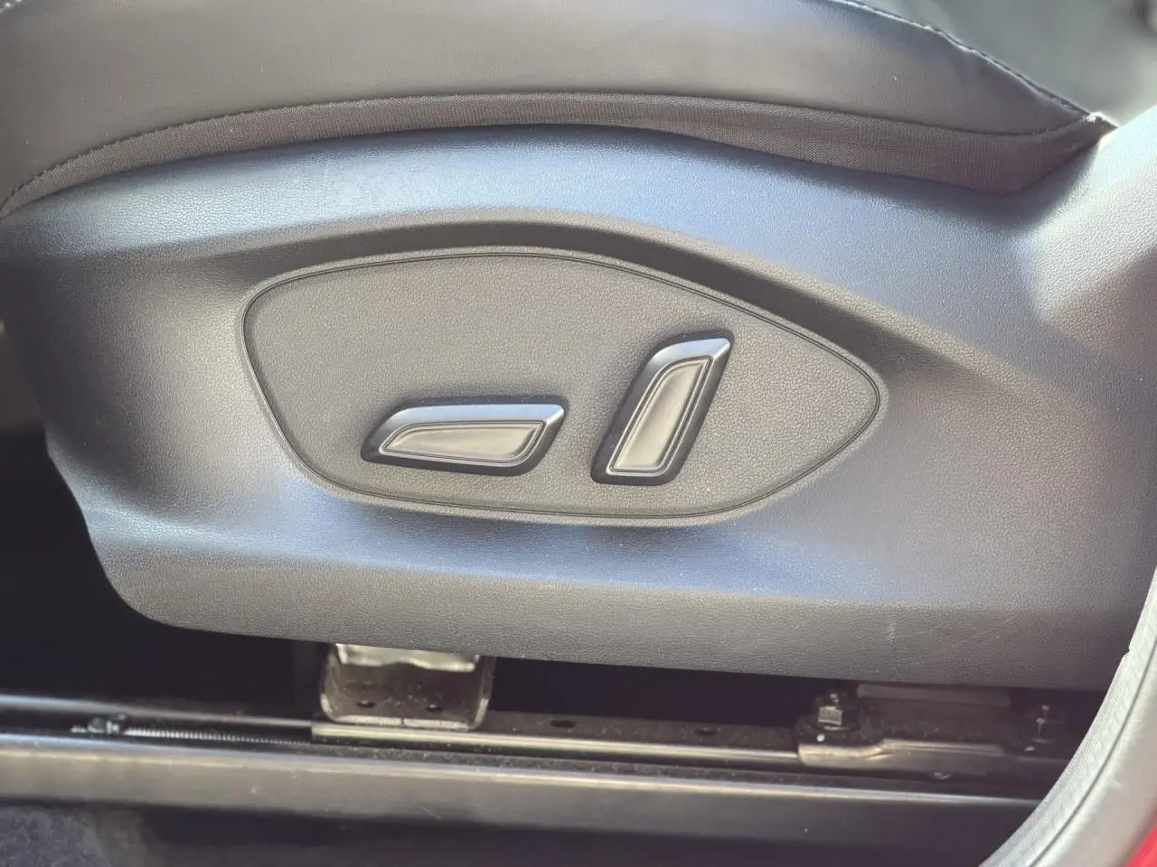 Gros plan sur les commandes électriques de réglage du siège avant côté conducteur du MG ZS 1.5 Hybrid+ 197 Luxury.