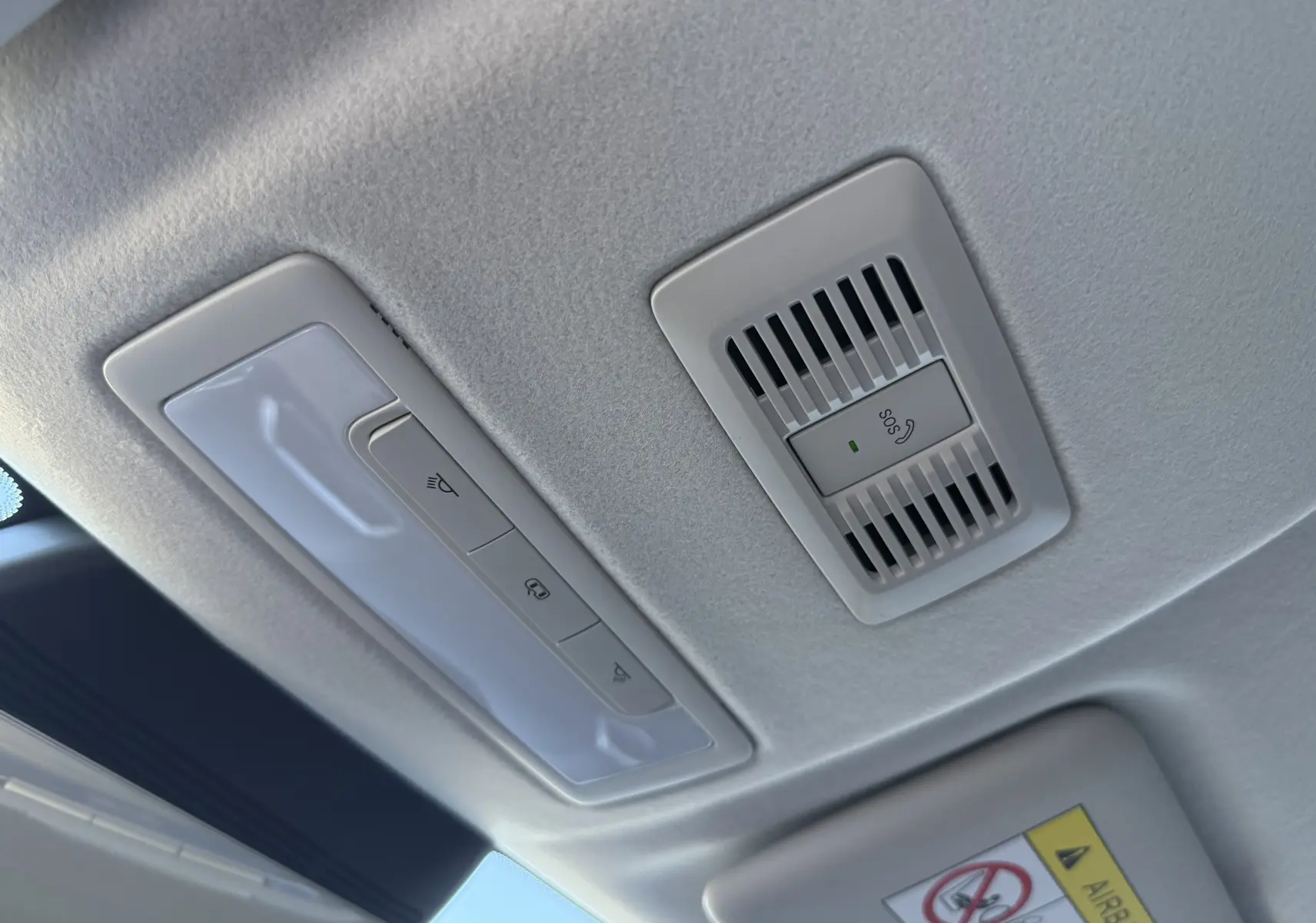 Plafonnier intérieur gris clair avec boutons de commande et alerte SOS du MG ZS 1.5 L Hybrid+ 2026 en vue rapprochée.