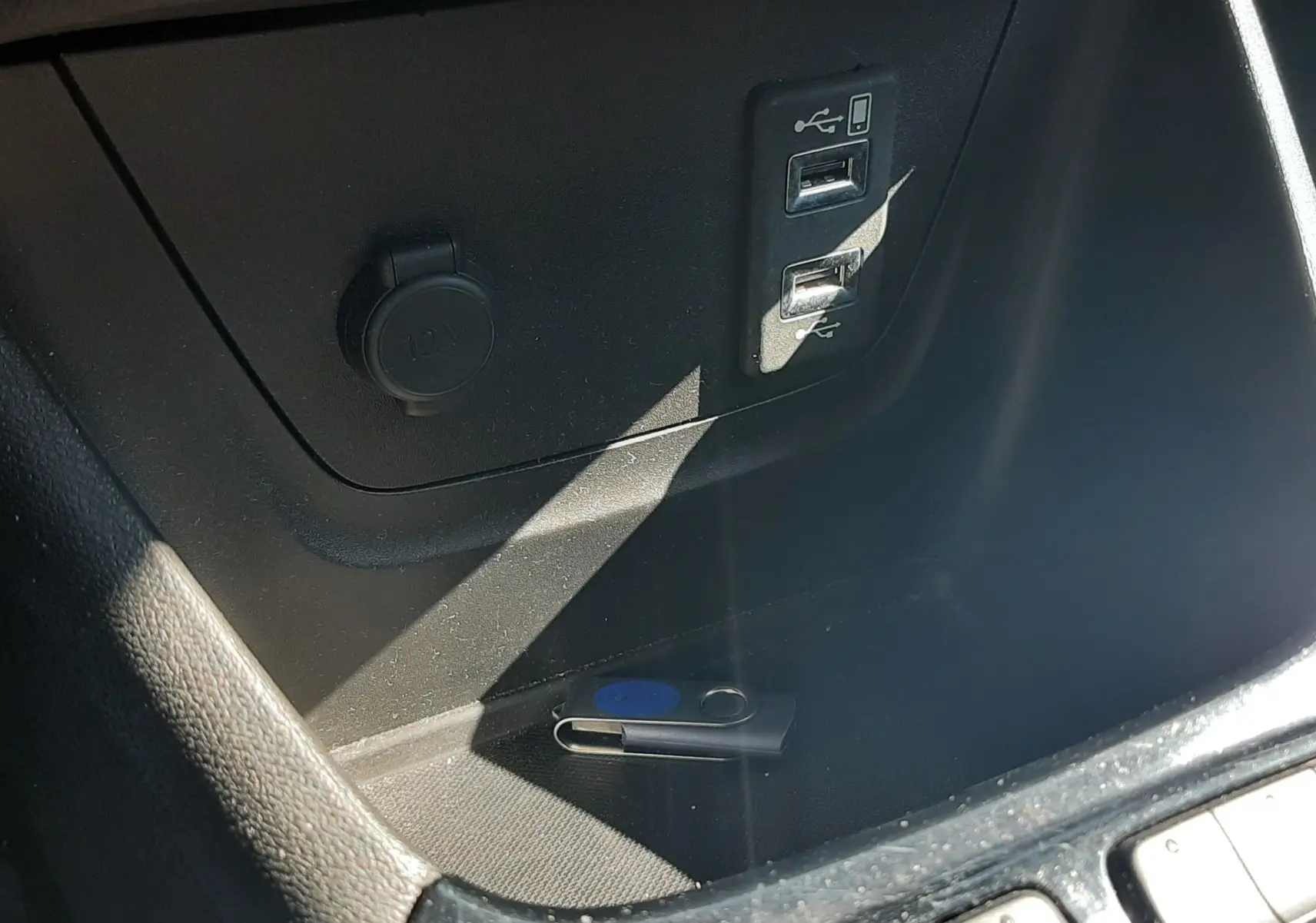 Gros plan sur la console centrale de l'Opel Crossland noir, montrant les boutons de contrôle et le soufflet de levier de vitesse en cuir.