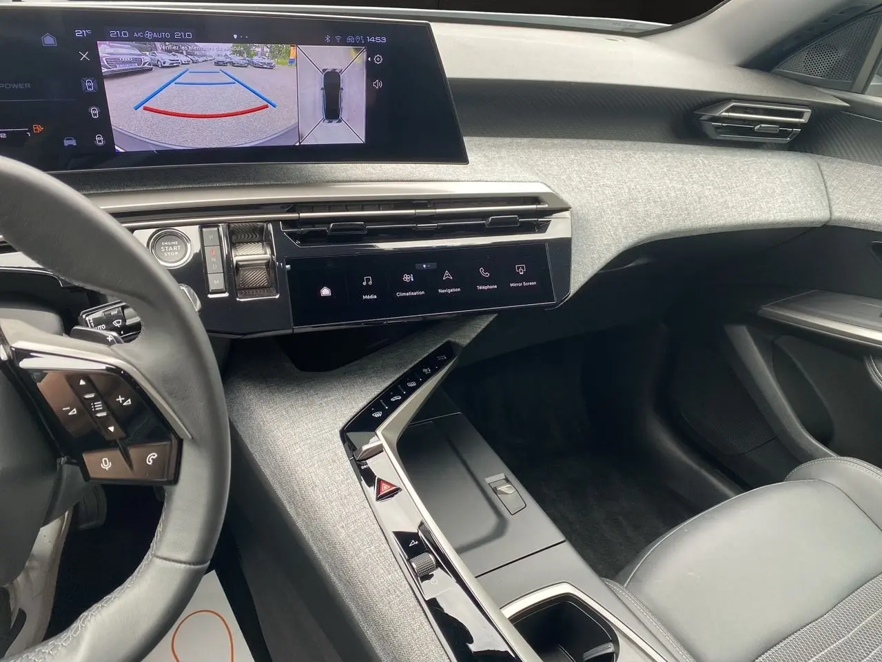 Intérieur moderne du Peugeot 3008 2024, vue côté passager avec écran tactile et volant partiel noir.