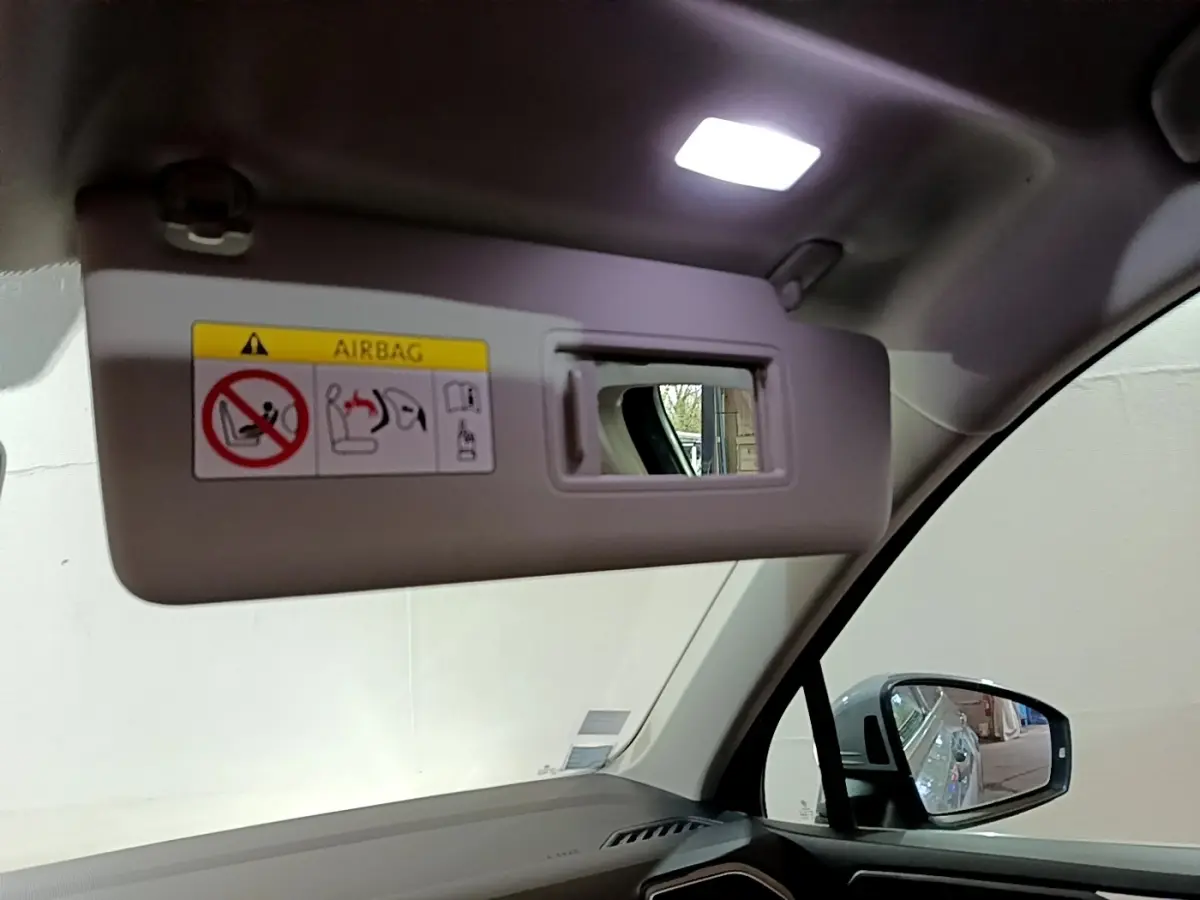 Détail du pare-soleil côté conducteur avec miroir intégré dans l'habitacle gris clair du Volkswagen Tiguan 2021.