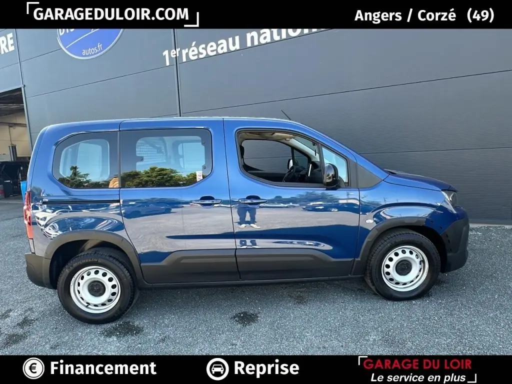 Profil côté gauche du Peugeot Rifter bleu 2024 avec jantes acier et finition noire sur bas de caisse.