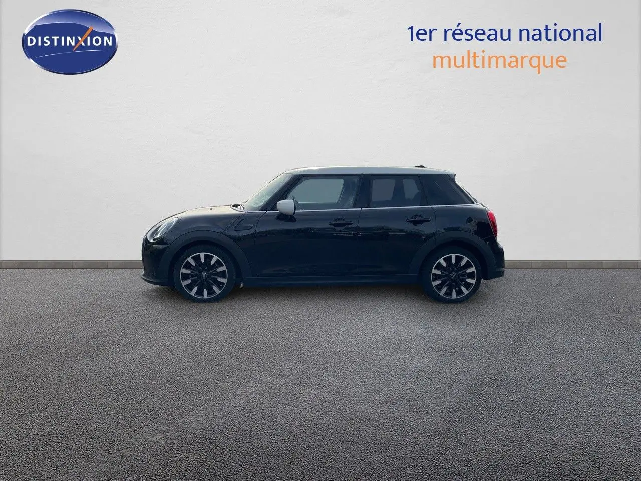 Profil côté gauche d'une MINI 1.5 136CH noire Midnight Metal avec toit blanc et jantes bi-ton 17 pouces.