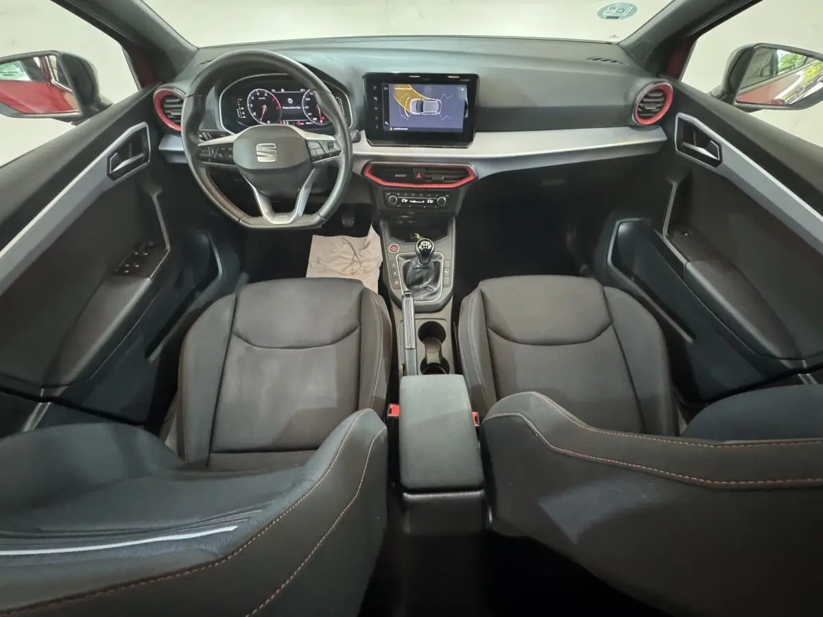Intérieur noir de la SEAT Ibiza 1.0 TSI 110 FR 2024, vue de dessus sur tableau de bord et sièges avant.