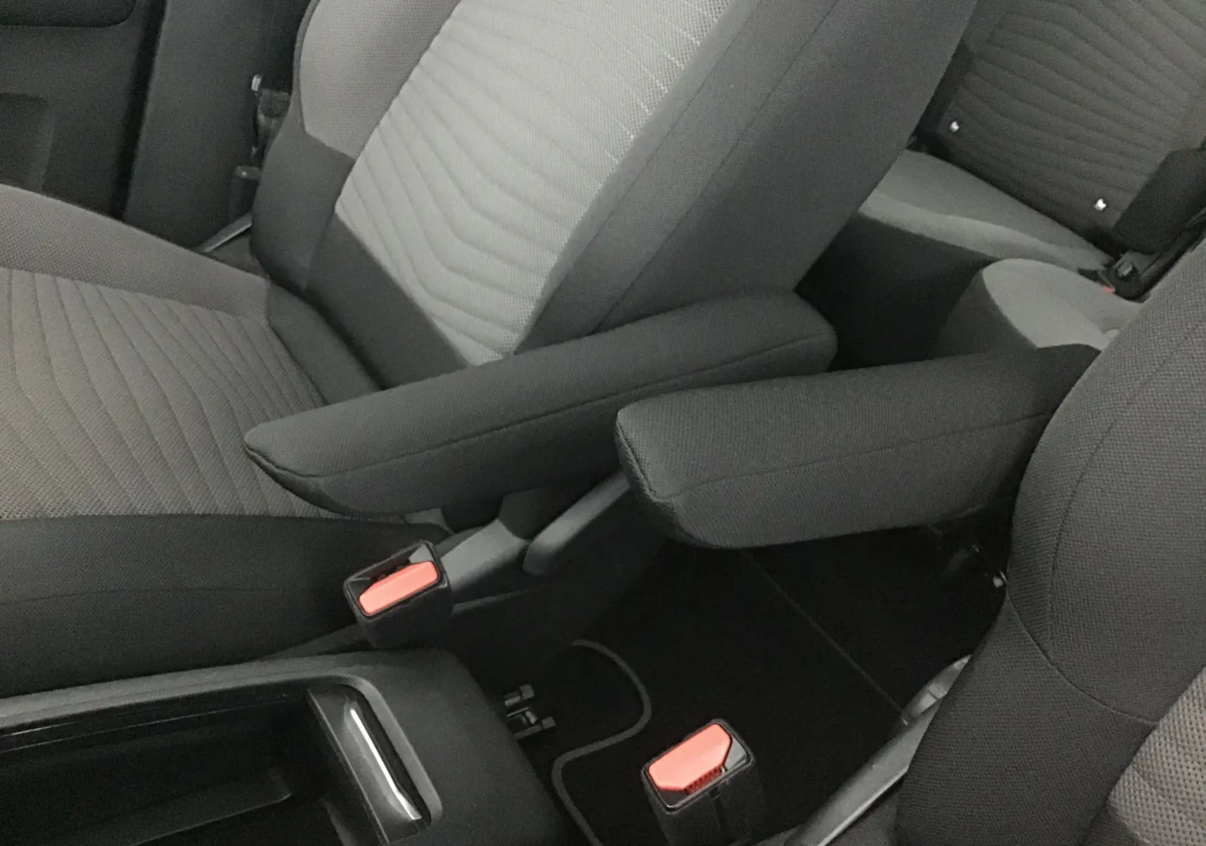 Gros plan sur les sièges avant gris clair et foncé du Citroën Grand C4 Spacetourer 2021 avec accoudoirs relevés.